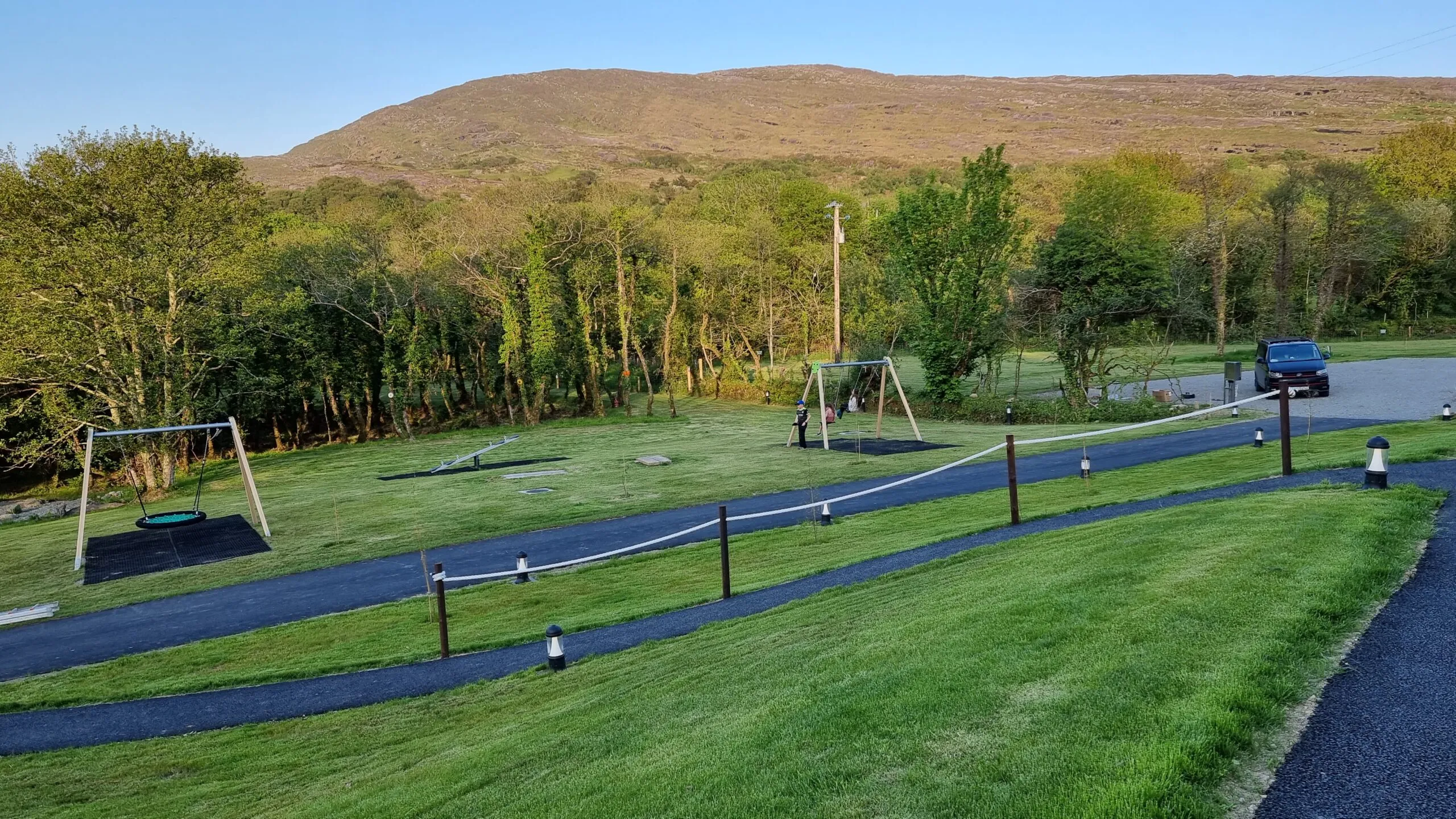 The green play area and riverside pitches at Goats Path campsite